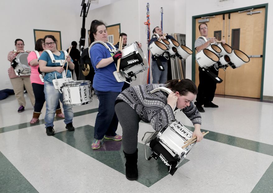 In this March 22, 2017, photo, members of the FREE Players Drum Corps prepare for a rehearsal, in Old Bethpage, N.Y. The 65-member band is composed entirely of adults with intellectual and physical disabilities. They've performed at Disney World in Florida and marched in New York City's Columbus Day Parade. Now they’ve been invited to play an exhibition at the 2018 world championships in Indianapolis. (AP Photo/Julie Jacobson)