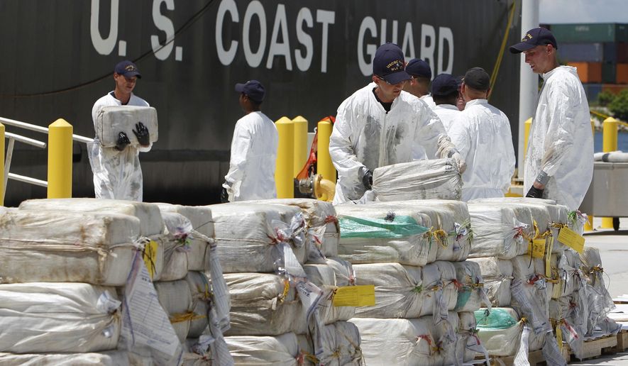 FILE - In this Aug. 2, 2011 file photo, U.S. Coast Guard crew members unload roughly 7.5 tons of cocaine, in Miami Beach, Fla., which was seized from a submarine-like craft off the Caribbean Coast of Honduras. During President Porfirio “Pepe” Lobo Sosa's 2010-2013 administration, Honduras had deteriorated into violent upheaval. In 2011, the U.N. ranked it as the country with the world’s highest murder rate. The U.S. State Department described it as “primary transshipment point” for U.S.-bound cocaine. (AP Photo/Lynne Sladky, File)
