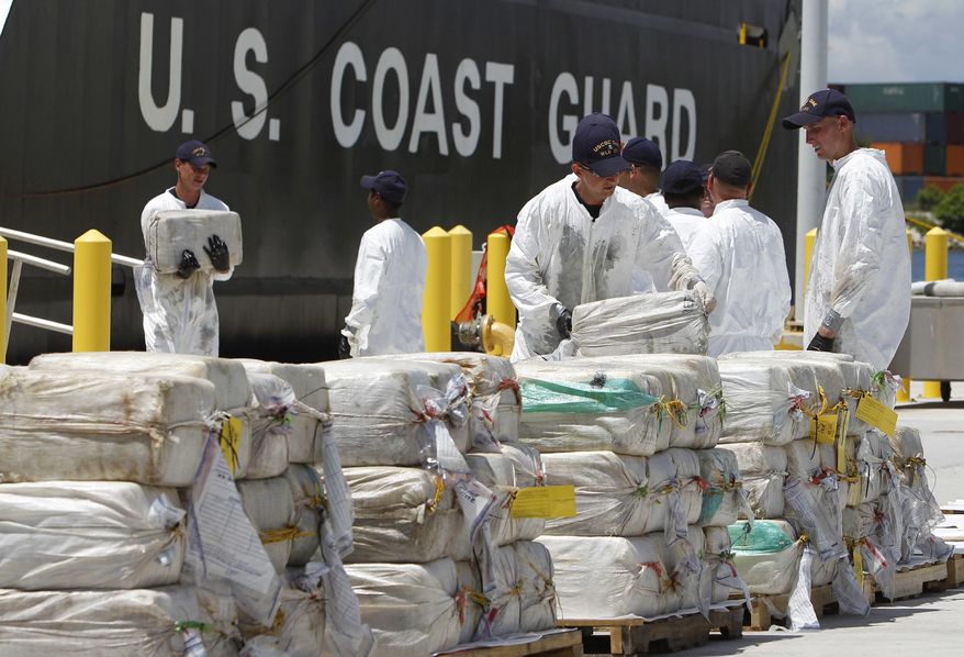 FILE - In this Aug. 2, 2011 file photo, U.S. Coast Guard crew members unload roughly 7.5 tons of cocaine, in Miami Beach, Fla., which was seized from a submarine-like craft off the Caribbean Coast of Honduras. During President Porfirio “Pepe” Lobo Sosa's 2010-2013 administration, Honduras had deteriorated into violent upheaval. In 2011, the U.N. ranked it as the country with the world’s highest murder rate. The U.S. State Department described it as “primary transshipment point” for U.S.-bound cocaine. (AP Photo/Lynne Sladky, File)