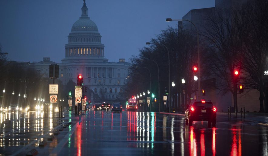 Capitol Hill is seen on the distance as rain falls on Pennsylvania Avenue in Washington, early Friday, March 31, 2017. (AP Photo/J. Scott Applewhite)