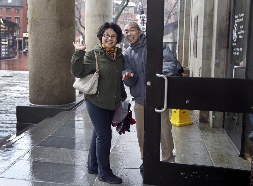 In this March 27, 2017 photo, tourists from China enter Quincy Market in Boston. In cities across the country, the American hospitality industry is stepping up efforts to make Chinese visitors feel more welcome. (AP Photo/Elise Amendola)