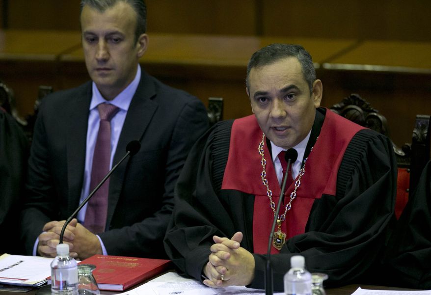 Venezuela&#39;s Vice-President Tareck El Aissami, left, and Supreme Court President Maikel Moreno during a meeting with Ambassadors from different countries and Diplomatics at the Supreme Court in Caracas, Venezuela, Saturday, April 1, 2017. Venezuela&#39;s president and Supreme Court backed down Saturday from an audacious move to strip congress of its legislative powers that had sparked widespread charges that the South American country was no longer a democracy. (AP Photo/Ariana Cubillos)
