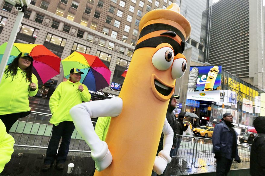 A dandelion crayon character poses for photos during a Crayola event in New York's Times Square, Friday, March 31, 2017. Crayola announced Friday, National Crayon Day, that it's replacing the color dandelion in its 24-pack with a crayon in "the blue family." (AP Photo/Richard Drew)