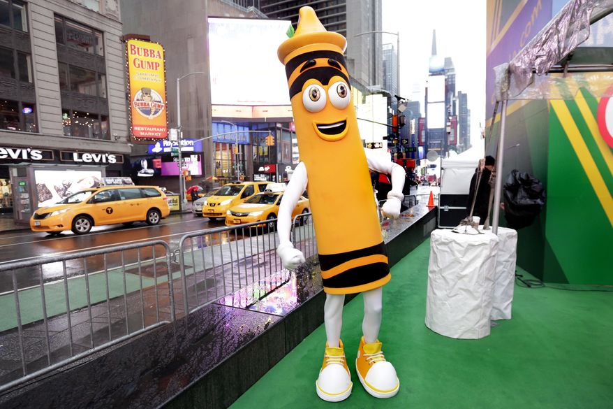 A dandelion crayon character poses for photos during a Crayola event in New York's Times Square, Friday, March 31, 2017. Crayola announced Friday, National Crayon Day, that it's replacing the color dandelion in its 24-pack with a crayon in "the blue family." (AP Photo/Richard Drew)