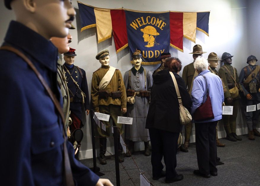 In this Nov. 4, 2016 photo, visitors walk through the exhibits which honor the centennial of WWI at the Michigan Military Heritage Museum in Grass Lake, Mich. Memorabilia honoring the centennial of WWI are on display during an open house at the museum, (Emily Mesner/Jackson Citizen Patriot via AP)