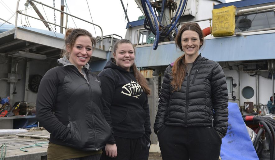 In this March 17, 2017 photo, Brannon Finney, from left, Kelsey Kubik and Bettina Nichols stand on the deck of the fishing tender Kamilar in the morning at Eliason Harbor in Sitka, Alaska. On a door of the F/V Kamilar is a sticker with pink script: Girls fish too. Vessel owner Finney is captaining the tender for the Sitka sac roe herring fishery with her all-female crew, something that¹s rare for the fast and frenzied commercial fishery. (James Poulson/The Daily Sitka Sentinel via AP)