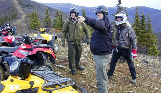 This 2005 photo provided by the Alaska Department of Natural Resources shows then-Rep. Mike Kelly, pointing, during a six-hour four-wheeler ride on a trail north of Two Rivers, Alaska, that had been made nearly impassible by state reclamation efforts. He called the trip &amp;quot;miserable and ugly.&amp;quot; Through his efforts, state officials agreed to rework the trail and preserve it. Kelly died at 74 in December, 2016 when a plane he was piloting crashed. In March, 2017, Gov. Bill Walker announced he has renamed the 13.5-mile trail as the &amp;quot;Mike Kelly Trail&amp;quot; on maps and signage. (Tim Mowry/Alaska Department of Natural Resources via AP)