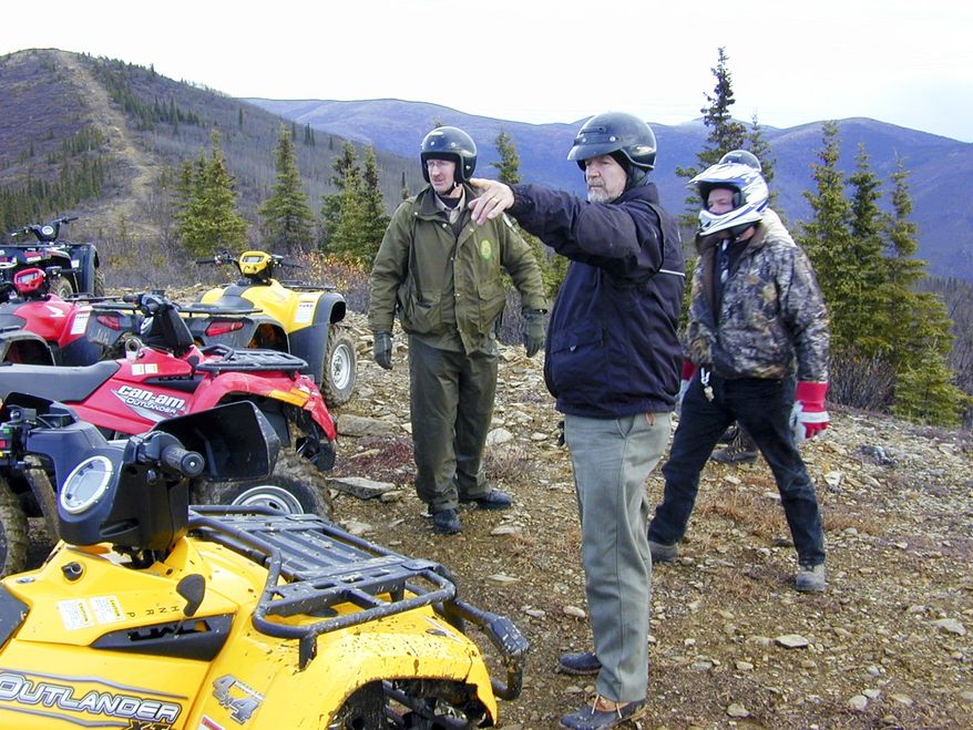 This 2005 photo provided by the Alaska Department of Natural Resources shows then-Rep. Mike Kelly, pointing, during a six-hour four-wheeler ride on a trail north of Two Rivers, Alaska, that had been made nearly impassible by state reclamation efforts. He called the trip "miserable and ugly." Through his efforts, state officials agreed to rework the trail and preserve it. Kelly died at 74 in December, 2016 when a plane he was piloting crashed. In March, 2017, Gov. Bill Walker announced he has renamed the 13.5-mile trail as the "Mike Kelly Trail" on maps and signage. (Tim Mowry/Alaska Department of Natural Resources via AP)