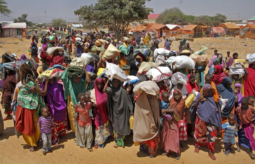 FILE - In this Thursday, March 30, 2017 file photo, new arrivals of Somalis displaced by the drought arrive at makeshift camps in the Tabelaha area on the outskirts of Mogadishu, Somalia. President Donald Trump's approval of greater U.S. military authority to pursue al-Qaida-linked extremists in Somalia will put civilians further at risk, experts say, especially as drought displaces thousands of people in areas that now will be considered a war zone. (AP Photo/Farah Abdi Warsameh, File)