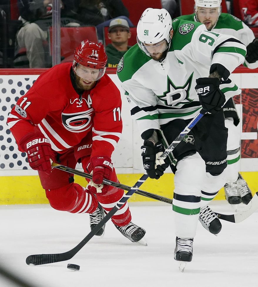 Dallas Stars&#39; Tyler Seguin (91) takes the puck away from Carolina Hurricanes&#39; Jordan Staal (11) during the first period of an NHL hockey game, Saturday, April 1, 2017, in Raleigh, N.C. (AP Photo/Karl B DeBlaker)