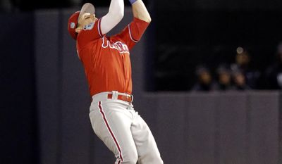FILE - In this March 15, 2017, file photo, Philadelphia Phillies second baseman Chris Coghlan catches a pop fly in the fifth inning of a spring training baseball game in Tampa, Fla. Coghlan spent spring training with the Phillies using a wrist band to measure his sleep and recovery.(AP Photo/John Raoux)