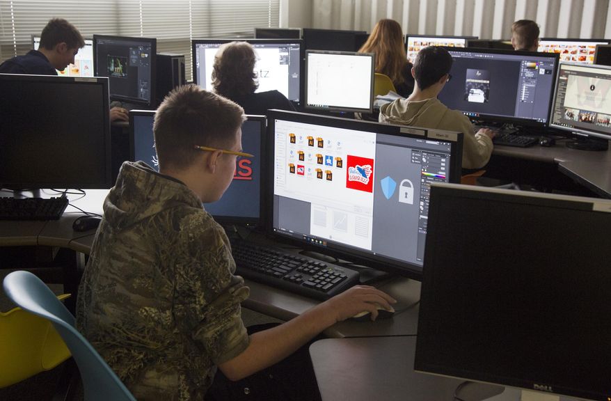 Students work on web page design projects at Meridian Technical Charter School Wednesday, March 8, 2017 in Meridian, Idaho. The charter school enrolls no more than 200 students each year in classes that cater to computer science, information technology, programing and web design. (Darin Oswald/Idaho Statesman via AP)