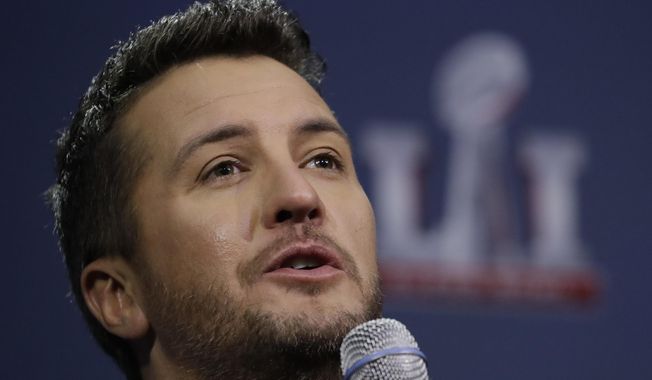 FILE - In this Feb. 2, 2017 file photo, Luke Bryan answers questions at a news conference for the NFL Super Bowl 51 football game  in Houston.  The Academy of Country Music Awards will unite the democrats and republicans, according to the show’s host, and part-time comedian, Luke Bryan.  &amp;quot;Coming to an election near you. Is politics your next career?” chimed in fellow country singer Dierks Bentley, who will co-host the show with Bryan on Sunday, April 2, 2017. (AP Photo/Morry Gash)