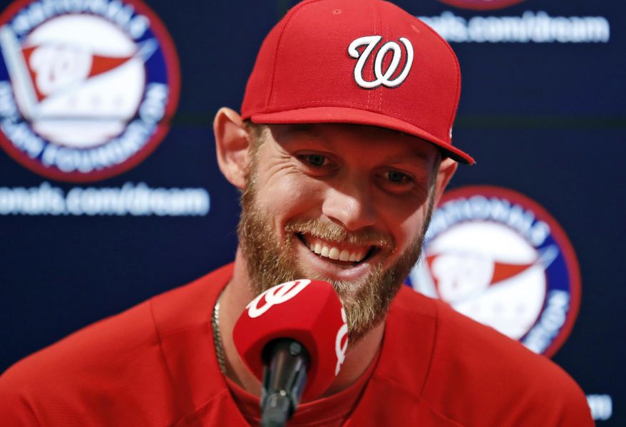 Washington Nationals starting pitcher Stephen Strasburg smiles during a media availability before a canceled exhibition baseball game against the Boston Red Sox at Nationals Park, Friday, March 31, 2017, in Washington. Strasburg will be the opening day starter. (AP Photo/Alex Brandon)