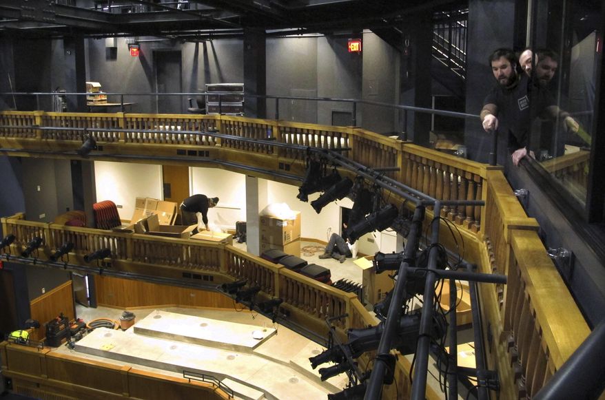 In this March 28, 2017 photo, crews install theater lighting and seating in the new Highland Center for the Arts in Greensboro, Vt. The $14 million facility, paid for by a summer resident, is set to open in early June. (AP Photo/Lisa Rathke)