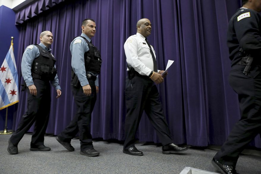Chicago Police Department Superintendent Eddie Johnson, right, leaves the room after talking with reporters about charging the first of several juvenile offenders from the March 19 criminal sexual assault incident broadcast on Facebook, during a press conference Sunday, April 2, 2017, at the City of Chicago Public Safety Headquarters. (Michael Tercha/Chicago Tribune via AP)