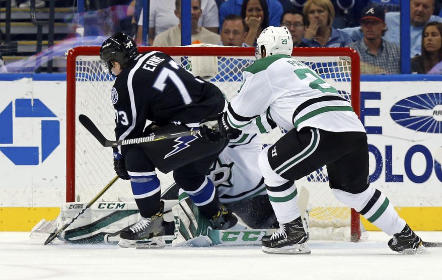 Tampa Bay Lightning&#39;s Adam Erne fights off the check of Dallas Stars&#39; Greg Pateryn to score during the first period of an NHL hockey game Sunday, April 2, 2017, in Tampa, Fla. (AP Photo/Mike Carlson)