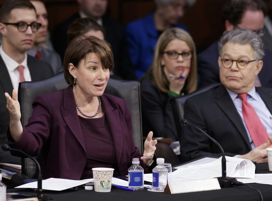 Democratic members of the Senate Judiciary Committee, Sen. Amy Klobuchar, D-Minn., and Sen. Al Franken, D-Minn., question the Republican side as the panel meets to advance the nomination of President Donald Trump&#39;s Supreme Court nominee Neil Gorsuch, Monday, April 3, 2017, on Capitol Hill in Washington.  (AP Photo/J. Scott Applewhite) ** FILE **