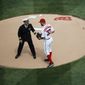 U.S. Navy Capt. Jeffrey Draeger, hands the ball to Washington Nationals starting pitcher Stephen Strasburg (37) during ceremonial game ball delivery at the opening day baseball game between the Washington Nationals and Miami Marlins in Washington, Monday, April 3, 2017.   (AP Photo/Manuel Balce Ceneta)