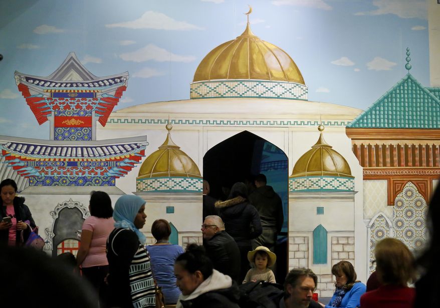 In this March 31, 2017 photo, a mural of a mosque appears at an exhibit called "America to Zanzibar: Muslim Cultures Near and Far," at the Children's Museum of Manhattan in New York. The exhibition, which runs through December allows children to explore Muslim cultures and traditions. (AP Photo/Bebeto Matthews)