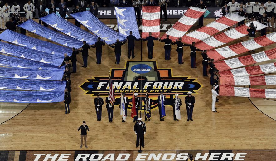The flag is displayed during the national anthem before the finals of the Final Four NCAA college basketball tournament, Monday, April 3, 2017, in Glendale, Ariz. (AP Photo/Morry Gash)