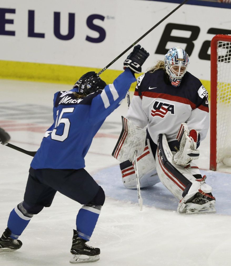 Finland defender Minttu Tuominen celebrates a goal by teammate Susanna Tapani on United States goalie Alex Rigsby (33) during the first period of a IIHF Women&#x27;s World Championship hockey tournament game, Monday, April 3, 2017, in Plymouth, Mich. (AP Photo/Carlos Osorio)