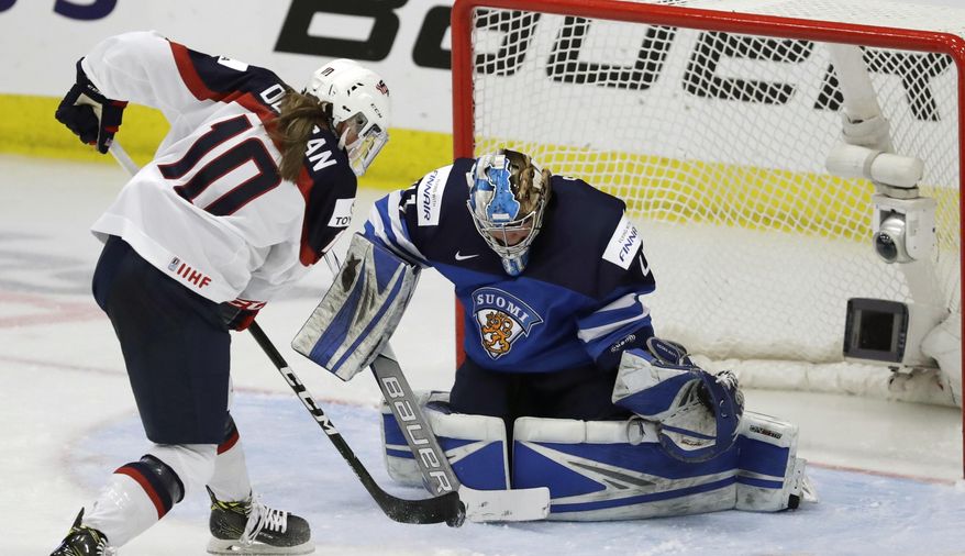 Finland goalie Noora Raty stops a shot by United States forward Meghan Duggan (10) during the second period of a IIHF Women&#x27;s World Championship hockey tournament game, Monday, April 3, 2017, in Plymouth, Mich. (AP Photo/Carlos Osorio)