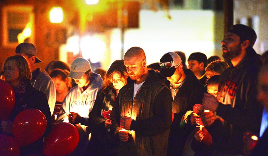 Friends, family and the St. Cloud State University, Minn., community gather to remember Jesse Dady at a candlelight vigil on Sunday, April 2, 2017, in St. Cloud, Minn. Authorities believe Dady fell from a railroad bridge into the Mississippi River where her body was found. (Ben Rodgers/St. Cloud Times via AP)