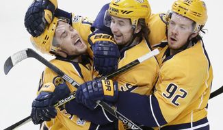 FILE - In this Feb. 25, 2017, file photo, Nashville Predators left wing Viktor Arvidsson, left, of Sweden, celebrates with Filip Forsberg (9), also of Sweden, and Ryan Johansen (92) after scoring an empty-net goal against the Washington Capitals during the third period of an NHL hockey game, in Nashville, Tenn. Filip Forsberg is the first in Predators&#x27; history to score 30 or more goals twice. Viktor Arvidsson is just behind enjoying the best season of his young career. Together, the young Swedes anchor Nashville&#x27;s top line pushing for a third straight playoff berth. (AP Photo/Mark Humphrey, File)
