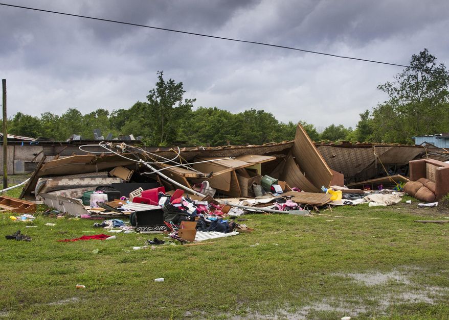 The remains of a trailer lie where a woman and her 3-year-old daughter were killed during a severe storm, in Breaux Bridge, La., Sunday, April 2, 2017. (Lucius Fontenot/The Daily Advertiser via AP)