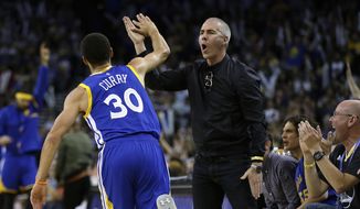 Golden State Warriors&#39; Stephen Curry celebrates with a fan after scoring against the Washington Wizards during the second half of an NBA basketball game Sunday, April 2, 2017, in Oakland, Calif. (AP Photo/Ben Margot)
