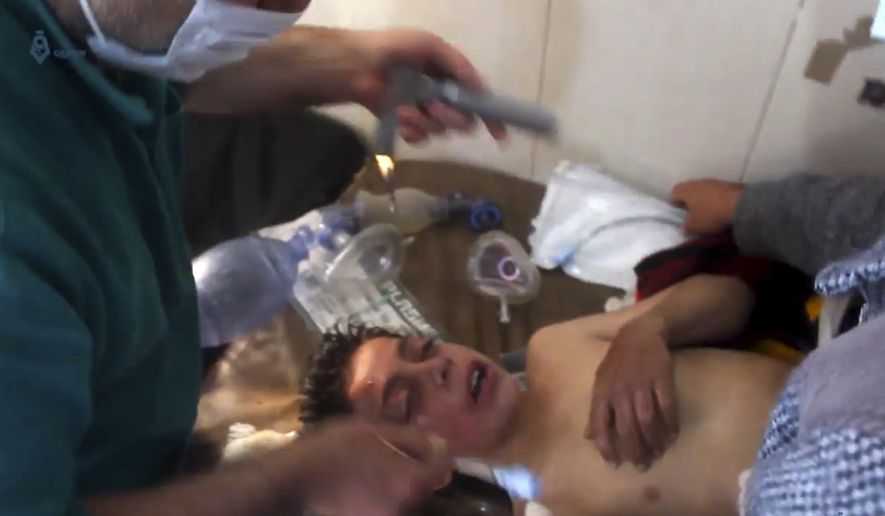 This frame grab from video provided on Tuesday April 4, 2017, by Qasioun News Agency, that is consistent with independent AP reporting, shows a Syrian doctor treating a boy following a suspected chemical attack, in the town of Khan Sheikhoun, northern Idlib province, Syria. The suspected chemical attack killed dozens of people on Tuesday, Syrian opposition activists said, describing the attack as among the worst in the country&#x27;s six-year civil war. (Qasioun News Agency, via AP)