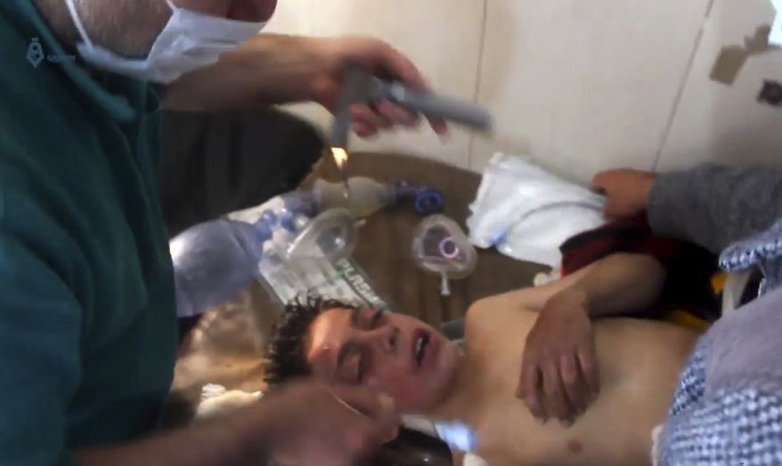This frame grab from video provided on Tuesday April 4, 2017, by Qasioun News Agency, that is consistent with independent AP reporting, shows a Syrian doctor treating a boy following a suspected chemical attack, in the town of Khan Sheikhoun, northern Idlib province, Syria. The suspected chemical attack killed dozens of people on Tuesday, Syrian opposition activists said, describing the attack as among the worst in the country&#39;s six-year civil war. (Qasioun News Agency, via AP)