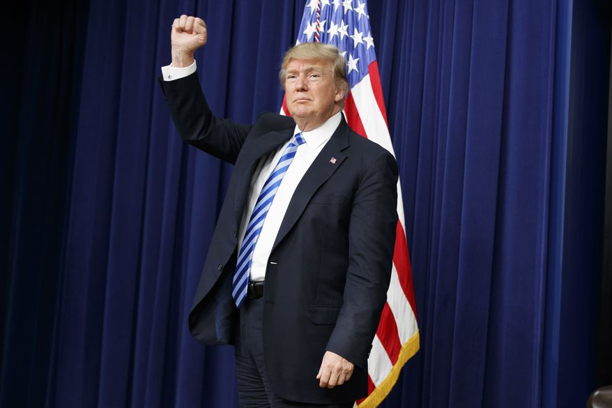 President Donald Trump pumps his fist during a town hall with business leaders in the South Court Auditorium on the White House complex in Washington, Tuesday, April 4, 2017. (AP Photo/Evan Vucci)