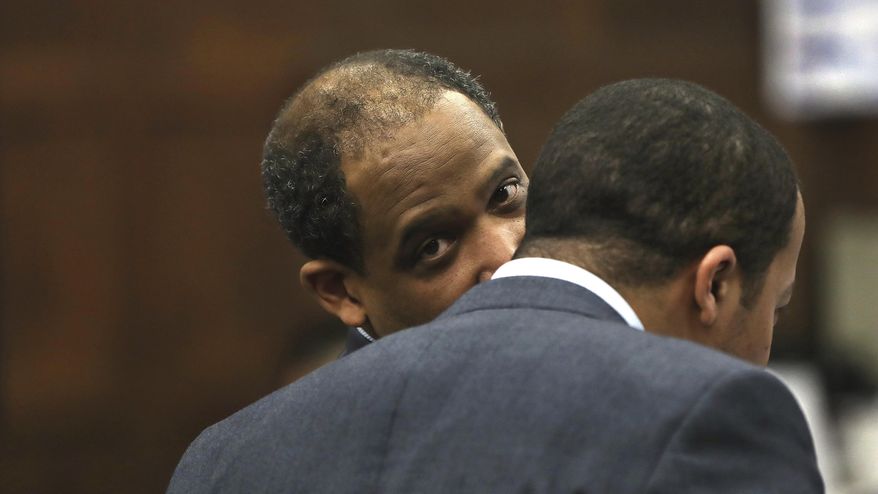 While making oral arguments before Judge Jeffrey Locke, defense attorney Ronald Sullivan, left, confers with legal intern Jeohn Favors Tuesday, April 4, 2017, during the trial of former New England Patriots tight end Aaron Hernandez in Suffolk Superior Court in Boston. Hernandez is standing trial for the July 2012 killings of Daniel de Abreu and Safiro Furtado, who he encountered in a Boston nightclub. The former NFL player is already serving a life sentence in the 2013 killing of semi-professional football player Odin Lloyd. (Pat Greenhouse/The Boston Globe via AP, Pool)