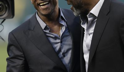 Former Oakland Athletic and Baseball Hall of Fame inductee Rickey Henderson, left, laughs with former Athletics pitcher Dave Stewart after a ceremony dedicating Rickey Henderson field prior to the baseball game against the Los Angeles Angels Monday, April 3, 2017, in Oakland, Calif. (AP Photo/Ben Margot)
