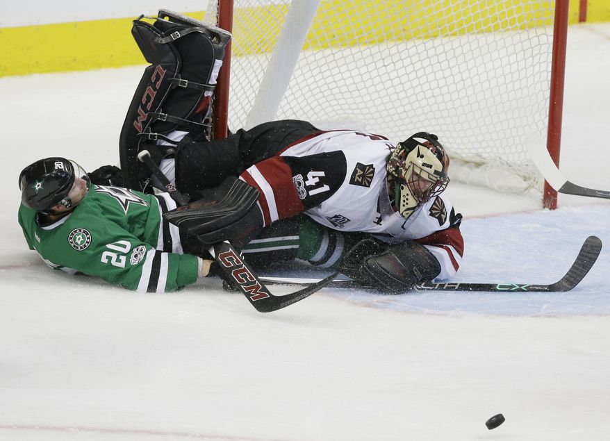 Arizona Coyotes goalie Mike Smith (41) and Dallas Stars center Cody Eakin (20) collide during the third period of an NHL hockey game in Dallas, Tuesday, April 4, 2017. The Stars won 3-2 in overtime. (AP Photo/LM Otero)