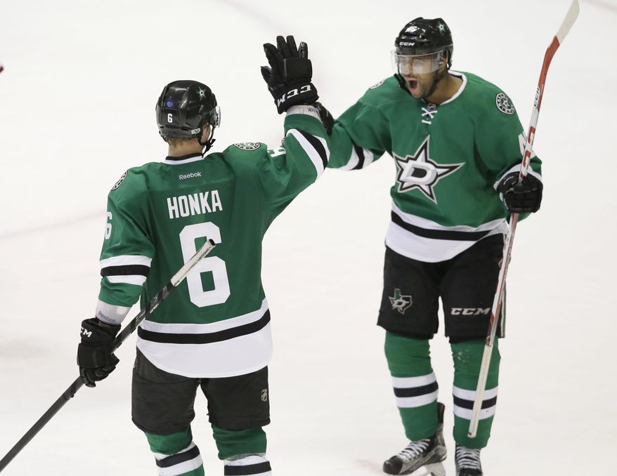 Dallas Stars defenseman Julius Honka (6) celebrates his game-winning goal with teammate Gemel Smith in overtime during an NHL hockey game against the Arizona Coyotes in Dallas, Tuesday, April 4, 2017. The Stars won 3-2. (AP Photo/LM Otero)