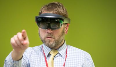 Brian Curtis demonstrates how to use a HoloLens self contained interaction computer prior to a groundbreaking ceremony for the future Dr. Edwin &amp;amp; Dorthy Balbach Davis Global Center for Advanced Interprofessional Learning at the University of Nebraska Medical Center Monday, April 3, 2017, in Omaha, Neb. (Brendan Sullivan/Omaha World-Herald via AP)