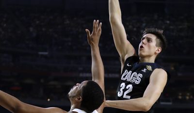 Gonzaga forward Zach Collins (32) shoots over North Carolina forward Kennedy Meeks (3) during the first half in the finals of the Final Four NCAA college basketball tournament, Monday, April 3, 2017, in Glendale, Ariz. (AP Photo/David J. Phillip)