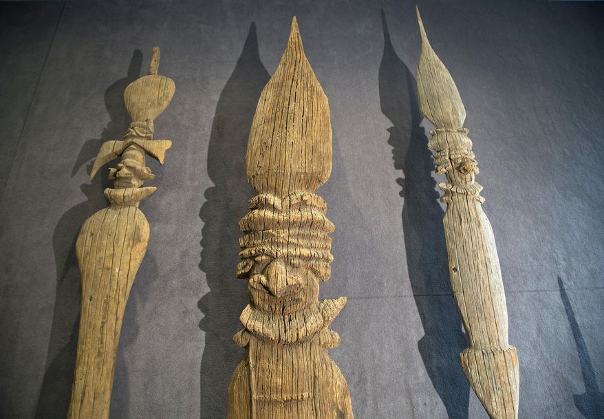 This photo dated Monday, April 3, 2017 shows various types of "fleche faitiere", decorated spears used by the Kanak to adorn their rooftops, on display at the Aguttes auction house in Neuilly sur Seine, outside Paris, France. A once-contested sale is going ahead in Paris of precious Kanak artifacts that were acquired by a private collector from the indigenous Melanesian inhabitants of New Caledonia. Nine wooden objects, including large decorative arrows dating from the 16th century, are to go under the hammer Tuesday. (AP Photo/Michel Euler)