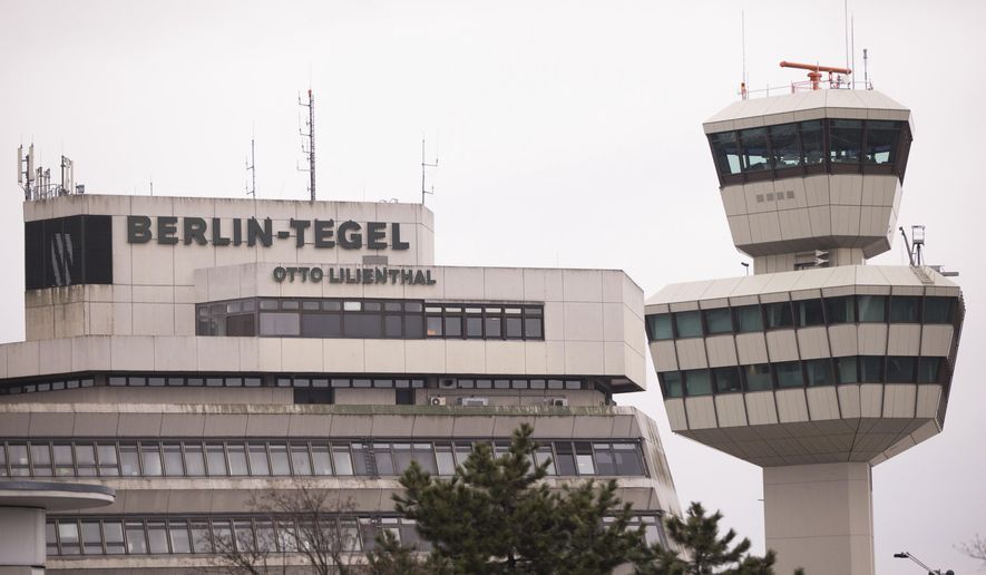FILE - In this March 20, 2017 file photo the main building and the tower of Tegel airport in Berlin are photographed. Plans to replace Berlin’s three small airports with a shiny new one have hit a fresh bump, after campaigners collected enough signatures to force a referendum on keeping a second site open. Officials said Tuesday, April 4, 2017 that over 200,000 people have signed a petition demanding that the Tegel airport in the northwest of the capital remain in operation. (Joerg Carstensen/dpa via AP,file)