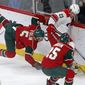 Minnesota Wild&#39;s Christian Folin, left, of Sweden, gets tripped up chasing the puck with Carolina Hurricanes&#39; Brock McGinn in the first period of an NHL hockey game Tuesday, April 4, 2017, in St. Paul, Minn. (AP Photo/Jim Mone)