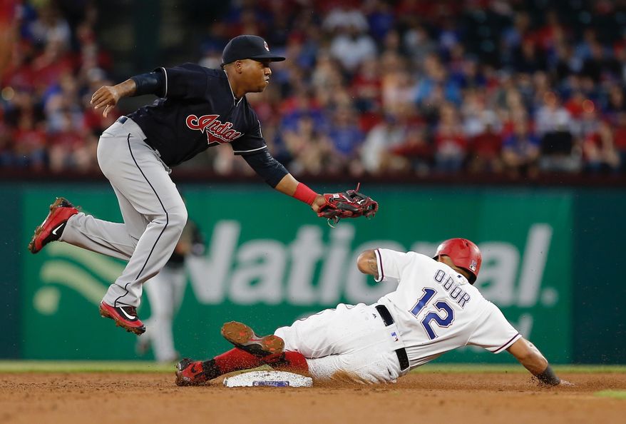 Cleveland Indians second baseman Jose Ramirez, left, forces out Texas Rangers Rougned Odor (12) during the second inning of a baseball game Tuesday, April 4, 2017, in Arlington, Texas. (AP Photo/Brandon Wade)