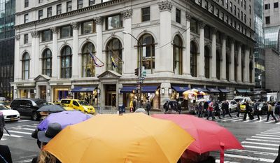 People pass the Polo Ralph Lauren store on Fifth Avenue, Tuesday, April 4, 2017, in New York. Ralph Lauren Corp. said that it is shuttering the high-profile store less than three years after opening it. The closure is part of the New York fashion company's plan to save $140 million annually. The company said it will close other stores, cut jobs and shut some corporate offices, but did not provide details. (AP Photo/Mark Lennihan)