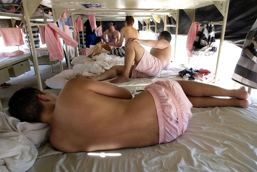 File - In this Wednesday, July 23, 2003, file photo, inmates sleep in county issued pink boxer shorts at the Maricopa County Jail's Tent City in Phoenix. Inmates live outside year round in tents outside due to overcrowding in the county's jails. Newly elected Maricopa County Sheriff Paul Penzone announced Tuesday, April 4, 2017, that he will be closing the facility in the coming months. (AP Photo/Matt York, File)
