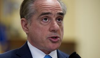 FILE - In this March 7, 2017, file photo, Secretary of Veterans Affairs David Shulkin, addresses a House Veterans&#39; Affairs Committee&#39;s hearing on Captiol Hill in Washington. The Department of Veterans Affairs is telling skeptical lawmakers it has already fixed problems with its suicide hotline that were highlighted in an internal watchdog’s report released just two weeks ago. (AP Photo/Cliff Owen, File)