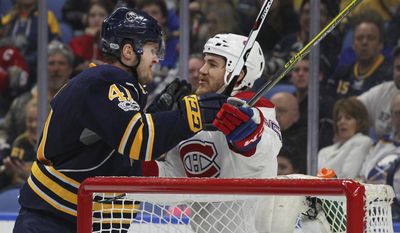 Buffalo Sabres defenseman Justin Falk (41) and Montreal Canadiens forward Andrew Shaw (65) get the sticks up during the second period of an NHL hockey game, Wednesday, April 5, 2017, in Buffalo, N.Y. (AP Photo/Jeffrey T. Barnes)
