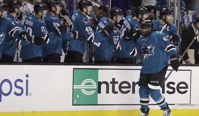 San Jose Sharks right wing Joel Ward, right, celebrates with teammates after scoring against the Vancouver Canucks during the first period of an NHL hockey game Tuesday, April 4, 2017, in San Jose, Calif. (AP Photo/Marcio Jose Sanchez)