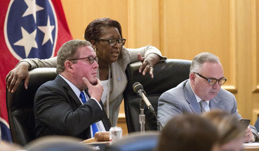 Rep. Gerald McCormick, R-Chattanooga, left, confers with Rep. Karen Camper, D-Memphis, before a House Finance Subcommittee in Nashville, Tenn., on Wednesday, April 5, 2017. Rep. Kevin Brooks, R-Cleveland is at right. The panel later voted to advance Republican Gov. Bill Haslam's road funding proposal that would include the state's first gas tax hike since 1989. (AP Photo/Erik Schelzig)